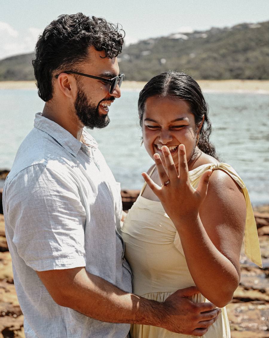 Sachini laughing as she shows her engagement ring, with Shubham beside her